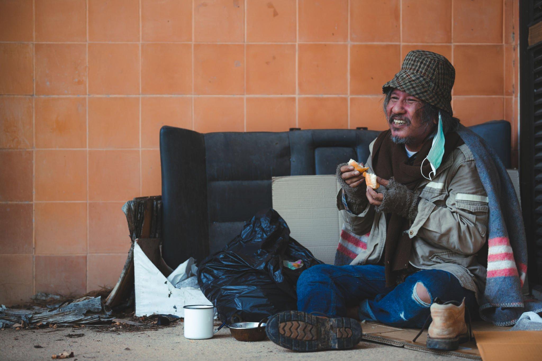 Homeless having food that he received in homeless winter survival kit